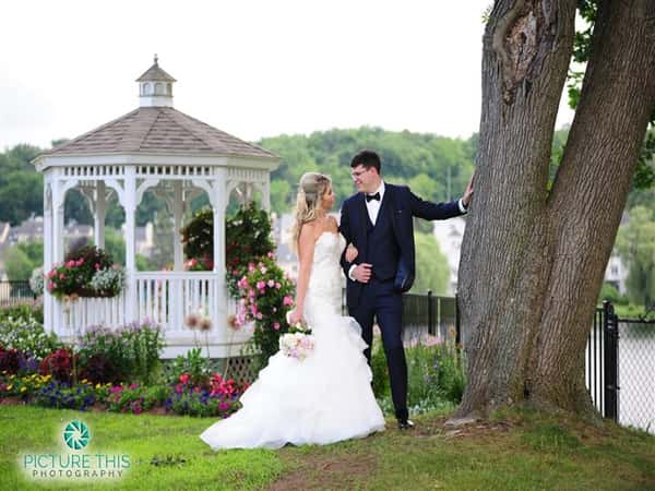couple kissing near the outdoor gazebo during the day