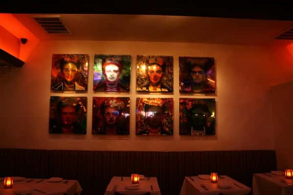 8 photos on the wall above tables