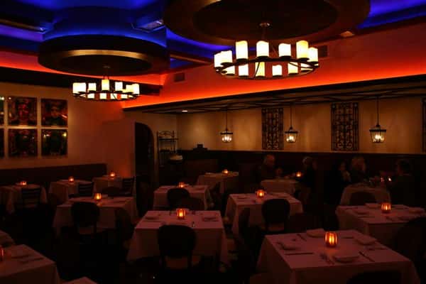 inside view of caracara mexican grill, with multiple tablecloth tables