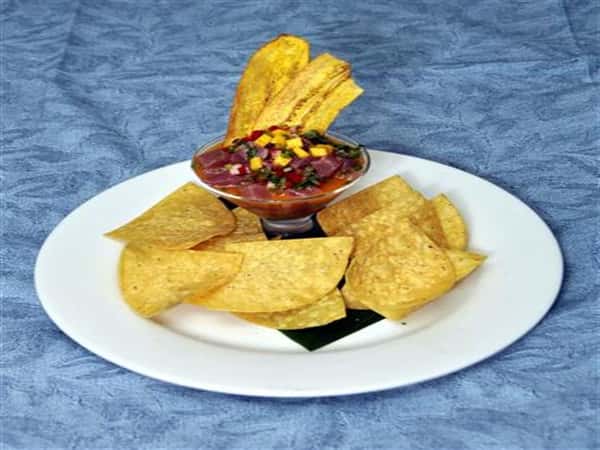 salsa with plantains dipped on, with chips on the side