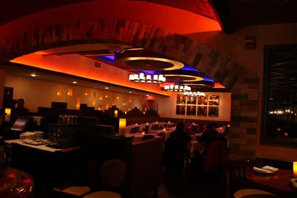 inside view of caracara mexican grill, with multiple tablecloth tables