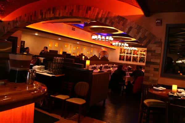 inside view of caracara mexican grill, with multiple tablecloth tables