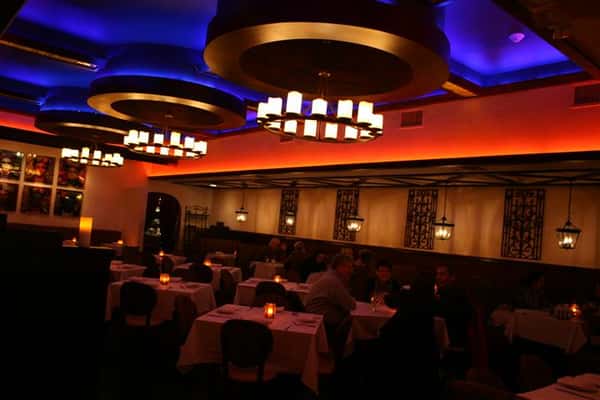 inside view of caracara mexican grill, with multiple tablecloth tables