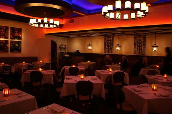 inside view of caracara mexican grill, with multiple tablecloth tables