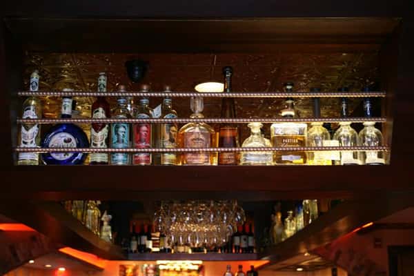bottles of liquor lined up above the bar