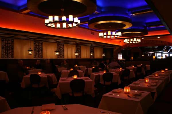 inside view of caracara mexican grill, with multiple tablecloth tables