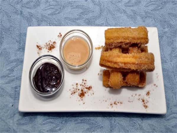 churros with two sides of different sauces to dip