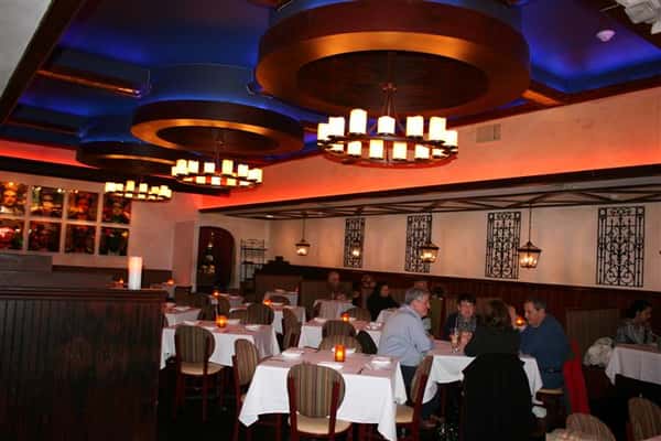 inside view of caracara mexican grill, with multiple tablecloth tables