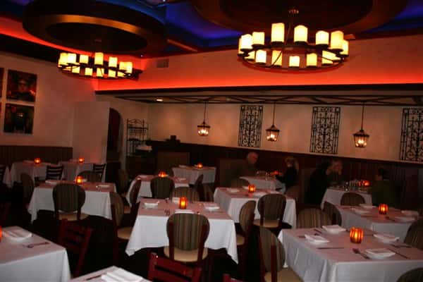 inside view of caracara mexican grill, with multiple tablecloth tables