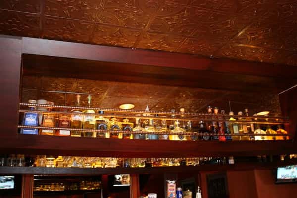 bottles of liquor lined up above the bar