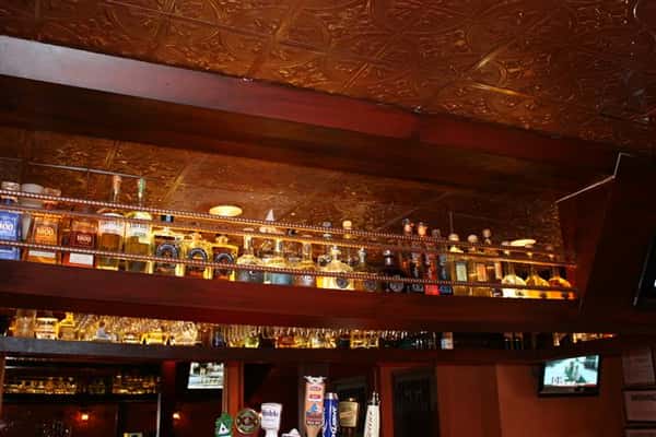 bottles of liquor lined up above the bar