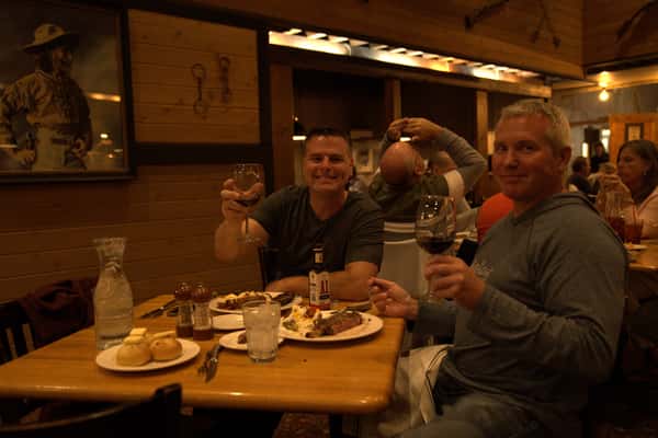 dining guests holding wine glasses