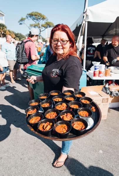 staff member holding a tray of food