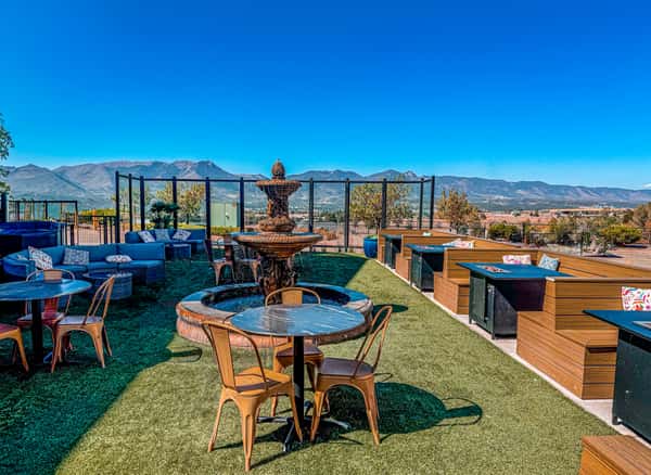 Rooftop patio with fountain seating, mountain views, and outdoor lounge space for dining, private events, and social gatherings.