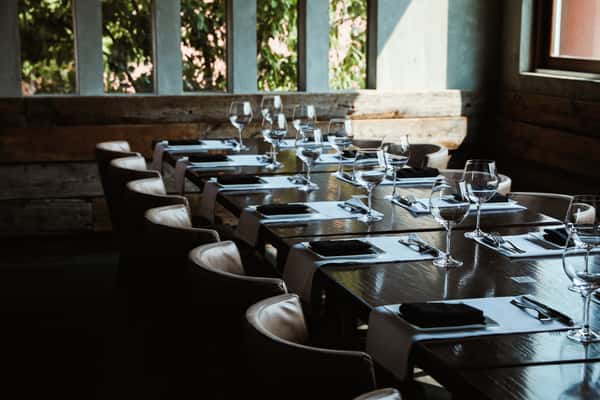 Discover the perfect setting for intimate gatherings in Kayne Prime's private event space, featuring elegantly set tables for a memorable experience.