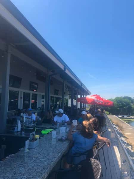 Customers sitting at the bar on the back patio