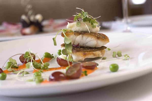 Crusted fish sliced grapes