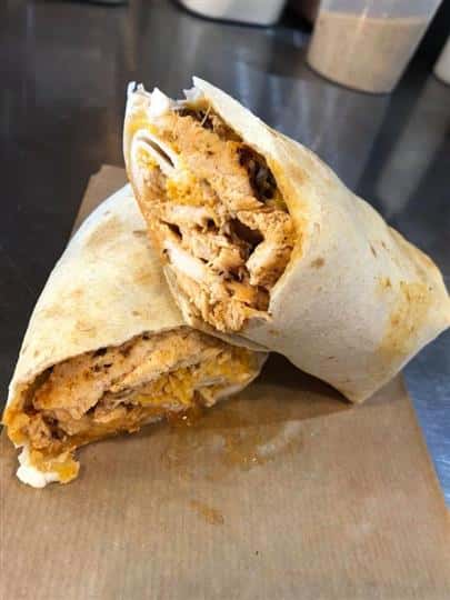 a delicious wrap cut in half and sitting on a napkin