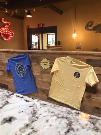two t-shirts that are mimi's coffeehouse merchandise