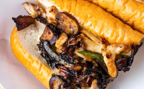 A long sandwich roll stuffed with grilled steak, sautéed mushrooms, and onions.