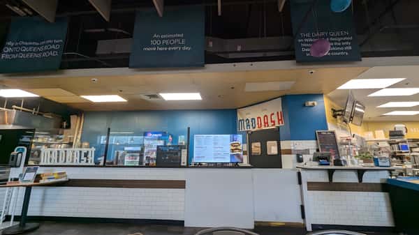 A wide shot of the restaurant's front service area and digital menu boards.