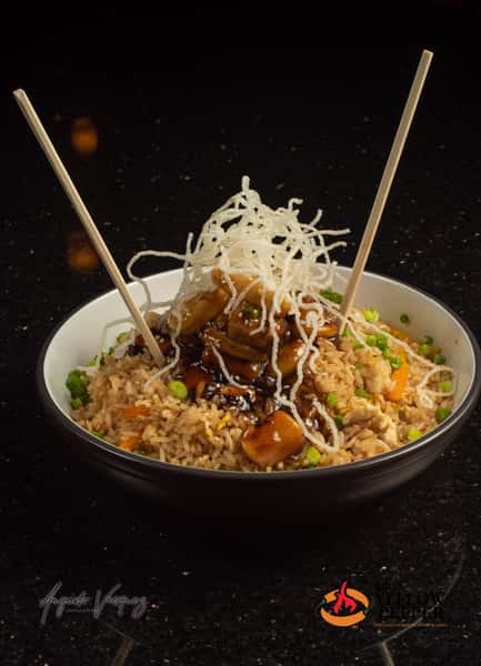 close up shot of food in a bowl with chopsticks