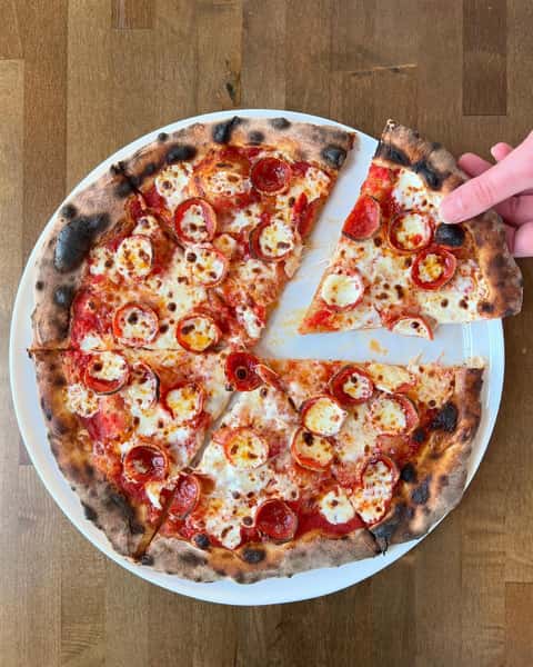A slide of pizza being taken