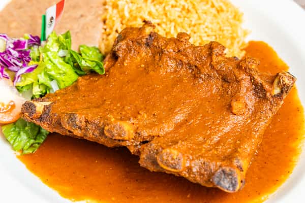 Tender ribs covered in rich red chile sauce and served with fresh garnish