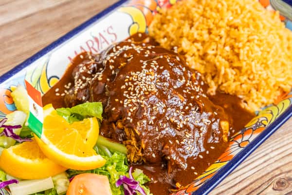 Rich Mexican mole entrée served with seasoned rice and fresh vegetables