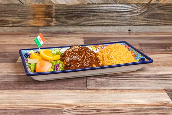 Traditional Mexican mole combination entrée served with rice and fresh sides