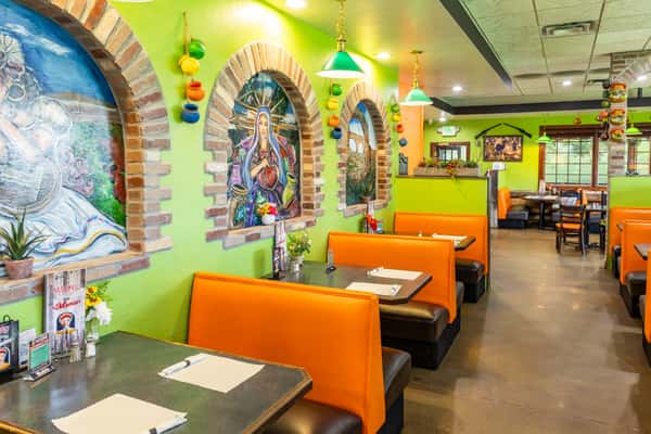 Colorful booth seating area with bright green and orange décor