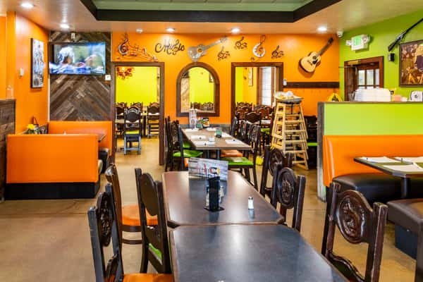 Warm and colorful dining area with booths, tables, and Mexican-inspired décor