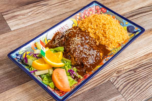 Traditional mole entrée served with Mexican rice and colorful fresh vegetables