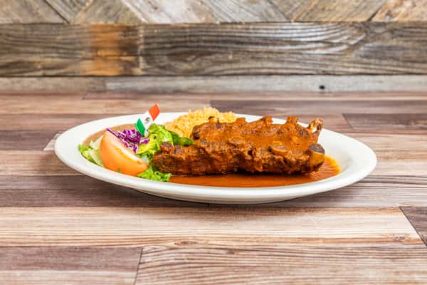 Tender ribs coated in savory red sauce and served with fresh garnish