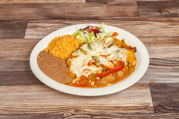Cheese-covered chile relleno served with rice, refried beans, and fresh vegetables