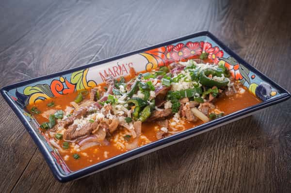 Seafood dish topped with fresh pico de gallo and cilantro on a Talavera platter