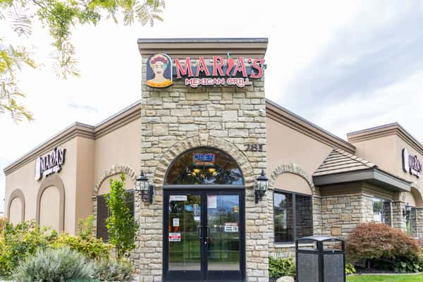 Close exterior view of Maria's Mexican Grill stone entrance and restaurant sign