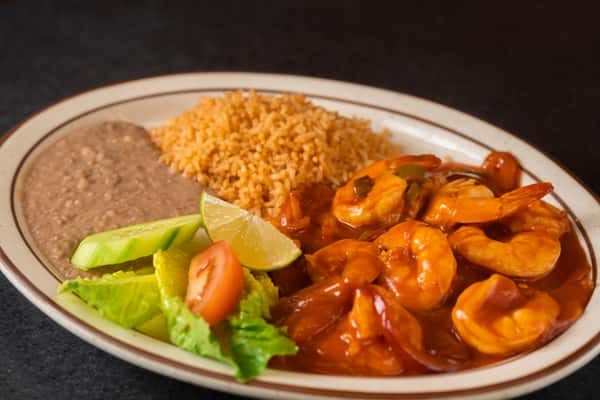 Shrimp in spicy red sauce with Mexican rice, refried beans and salad