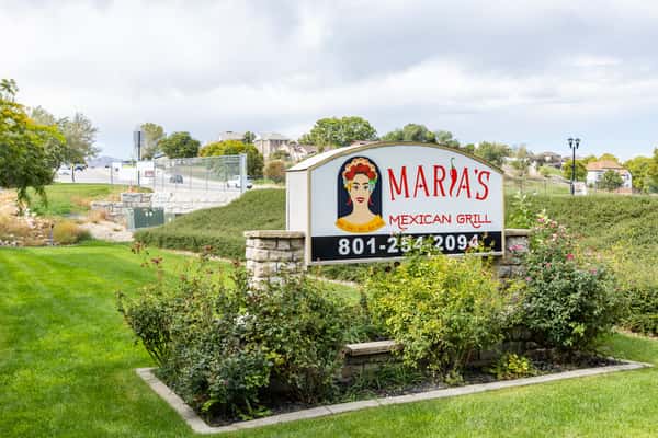 Maria's Mexican Grill roadside sign surrounded by landscaped greenery