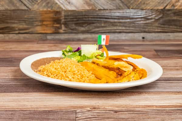 Traditional tamale entrée served with Mexican rice, beans, and fresh garnish