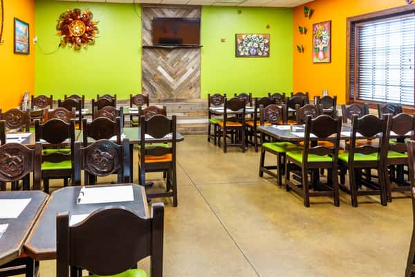 Bright dining room at Maria's Mexican Grill with colorful walls and dark wood tables