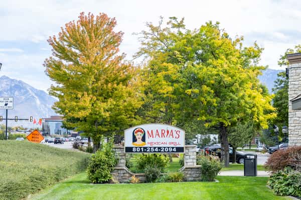 Maria's Mexican Grill roadside sign surrounded by trees and landscaping