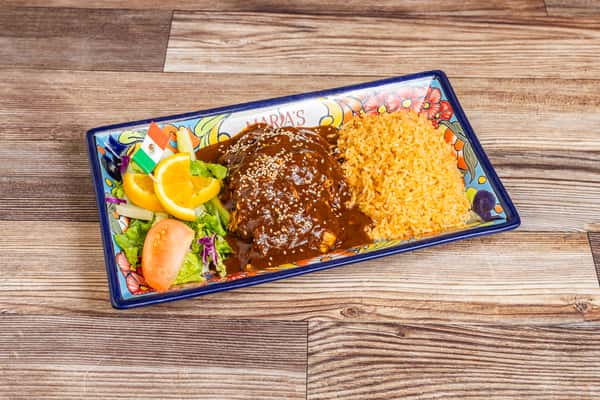Traditional mole entrée served with Mexican rice, beans, salad, and fresh garnish