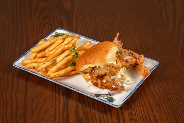 soft shell crab sandwich with fries served on a white plate