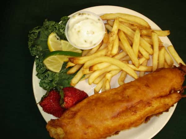 Fried fish with French fries and strawberries