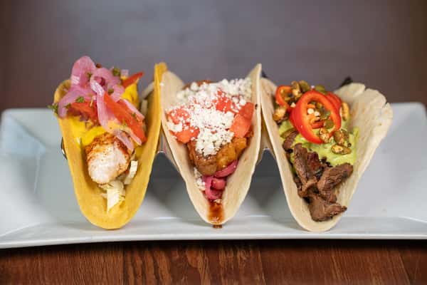 Flying fish taco, pork belly taco, and steak taco