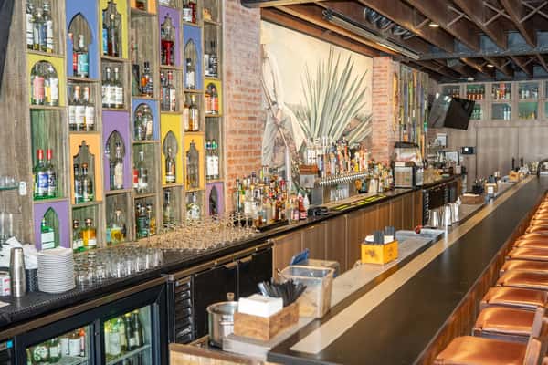 Bar area with shelves full of alcoholic beverages