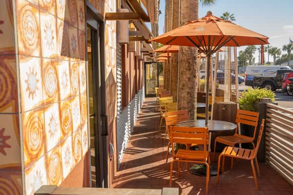 Exterior patio area with tables, chairs and umbrellas