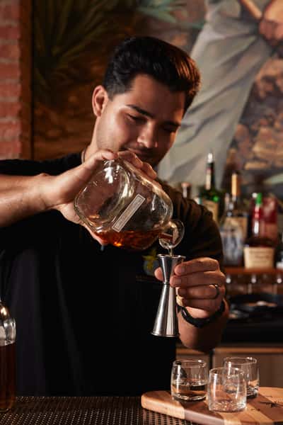 bartender pouring liquor
