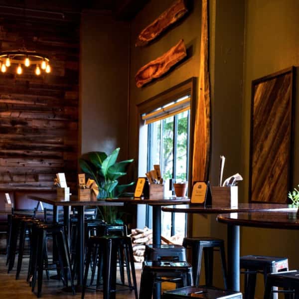 Cozy dining corner at Hardwood Bar & Smokery in San Francisco featuring natural light, warm wood accents, and an inviting setting for private dinners and social gatherings
